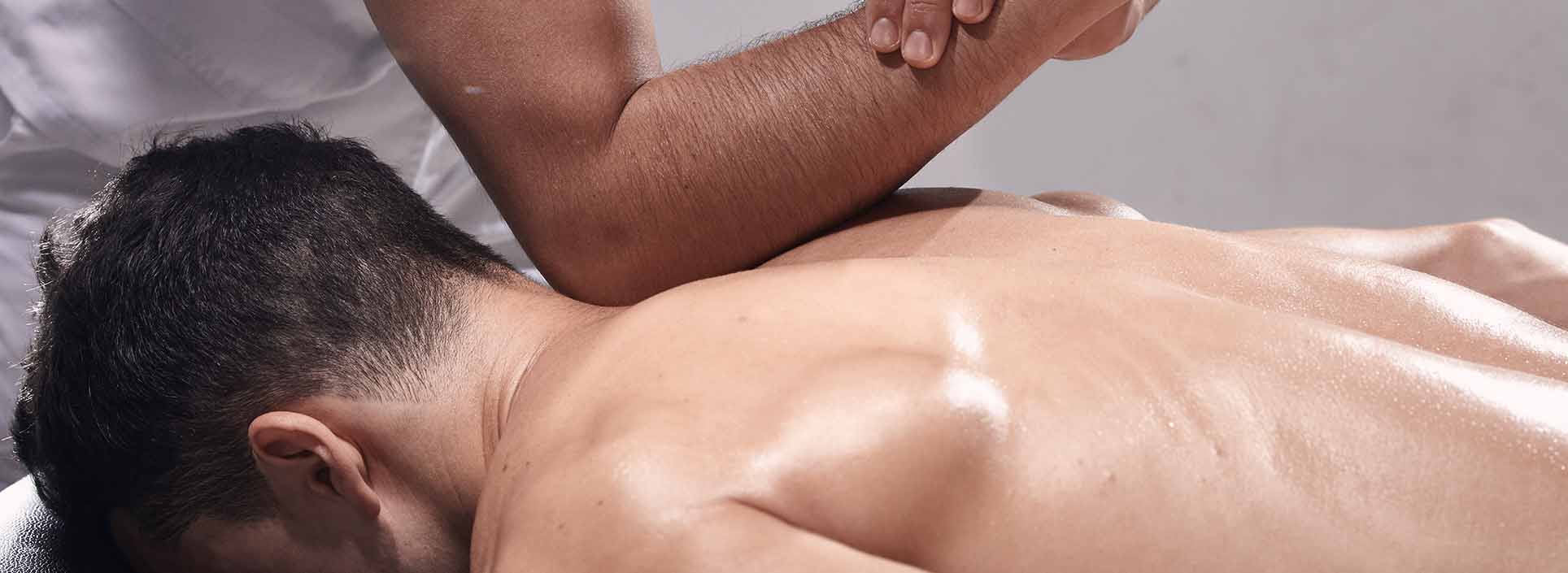 Physiotherapist sports-massage to patient